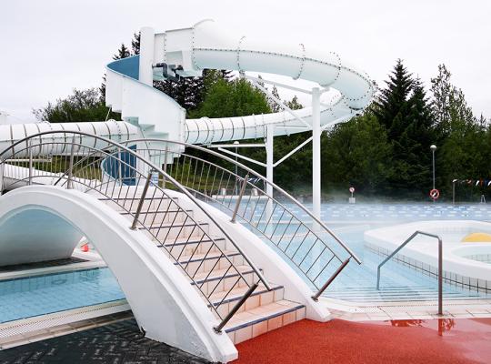 Walking bridge and slide at Árbæjarlaug