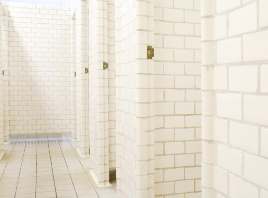 The old changing rooms at Sundhöll Reykjavík Pool. White-tiled walls and floors.