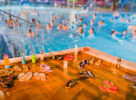 A crowded swimming pool with swimmers partially visible