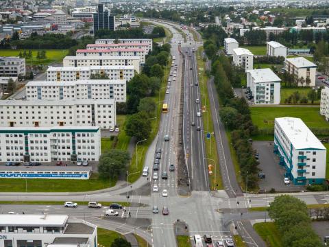 aerial view, road, cars, and apartment buildings.