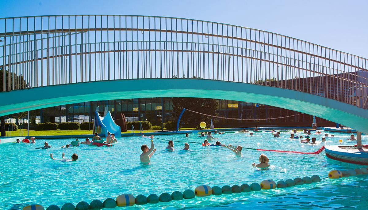 Children and adults playing in the children's pool at Laugardalslaug Pool