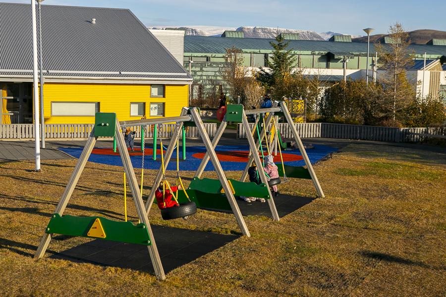 Children and playground equipment on Maríuborg's grounds.