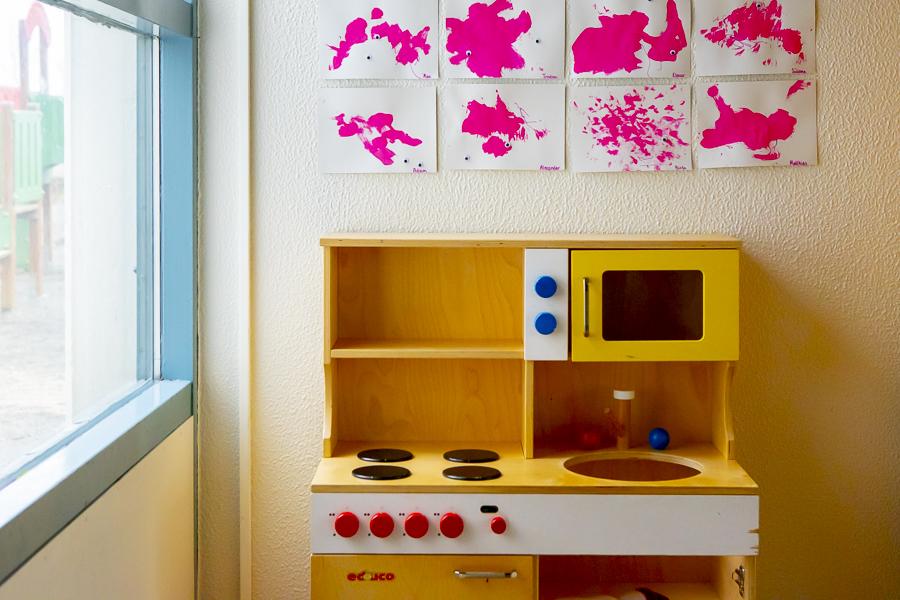 Leikfanga eldhús og listaverk á vegg á leikskólanum Sunnufold