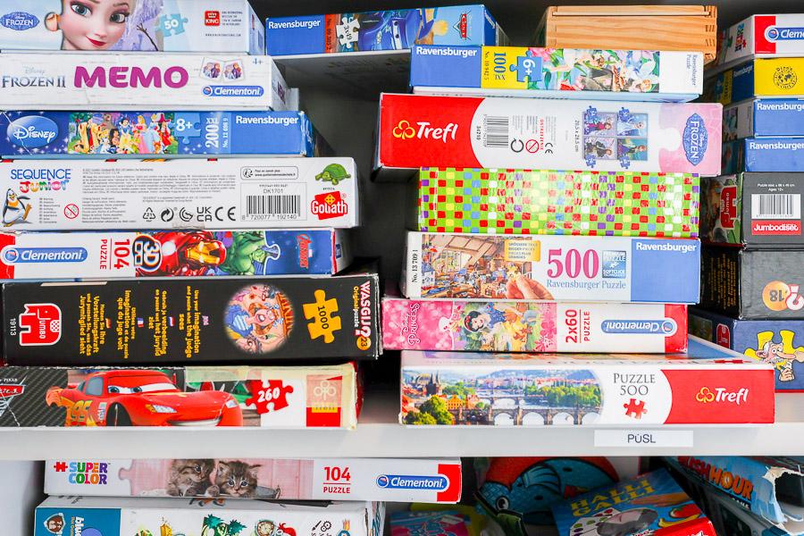 Puzzles on a shelf.
