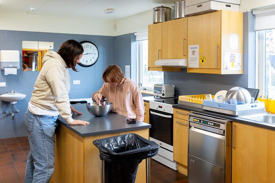 Young people baking in a kitchen. 