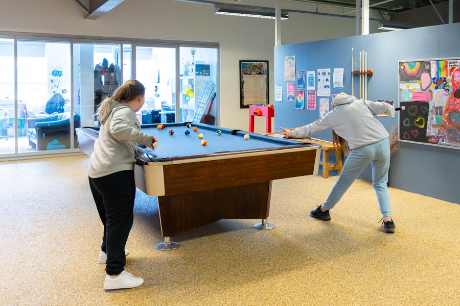 Young people playing pool.