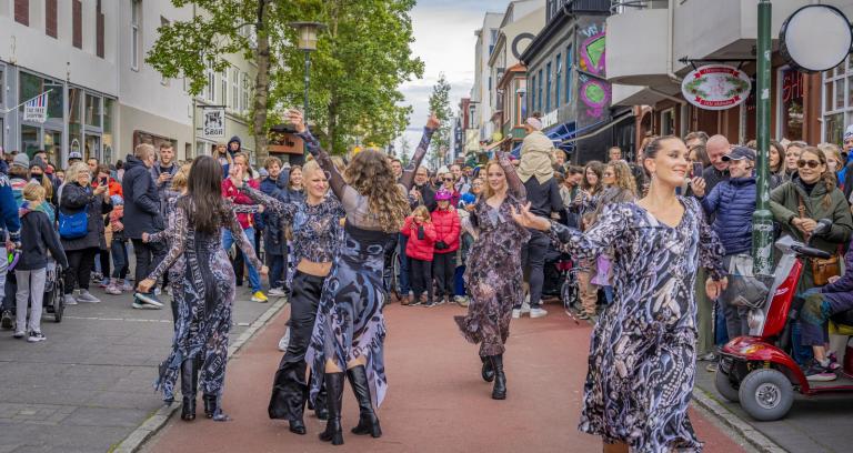 Dance performance during Culture Night, women in matching dresses dance on the red section of Laugavegur