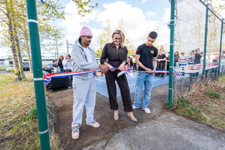 The mayor and two young people cutting a ribbon.